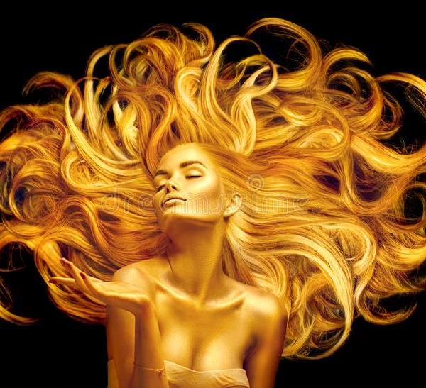 golden beauty woman sexy model girl golden makeup long hair pointing hand over black metallic gold glowing skin golden 150668962